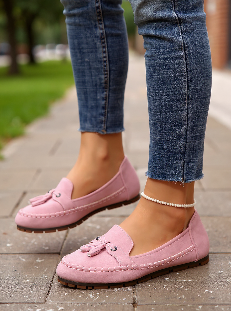 Pink tassel loafer on foot, walking