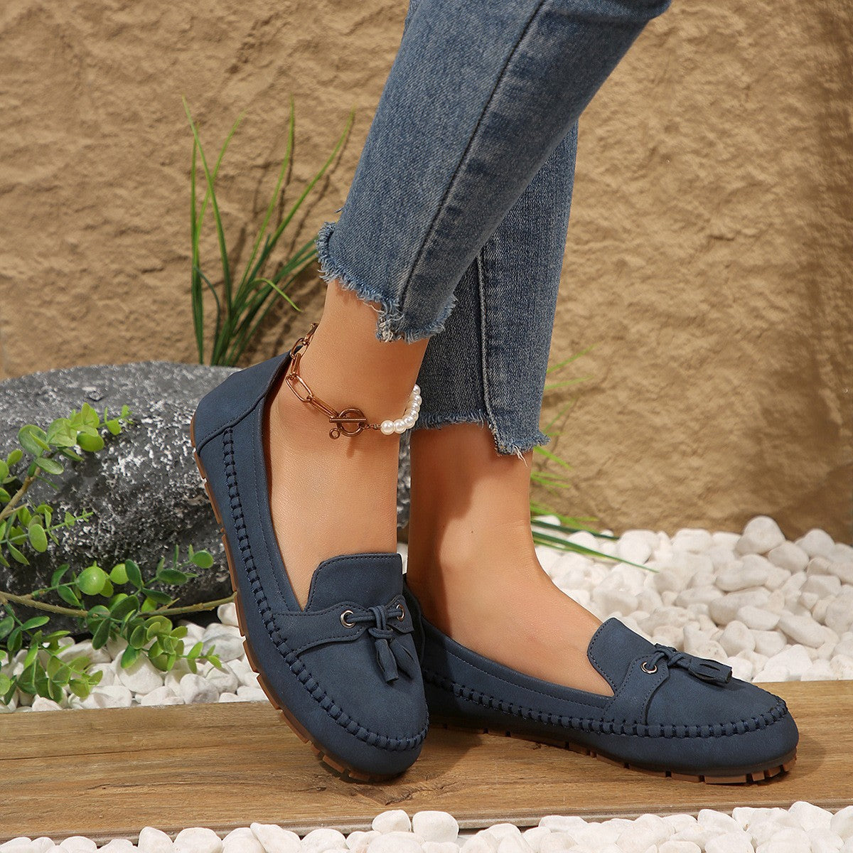 Navy tassel loafer on foot